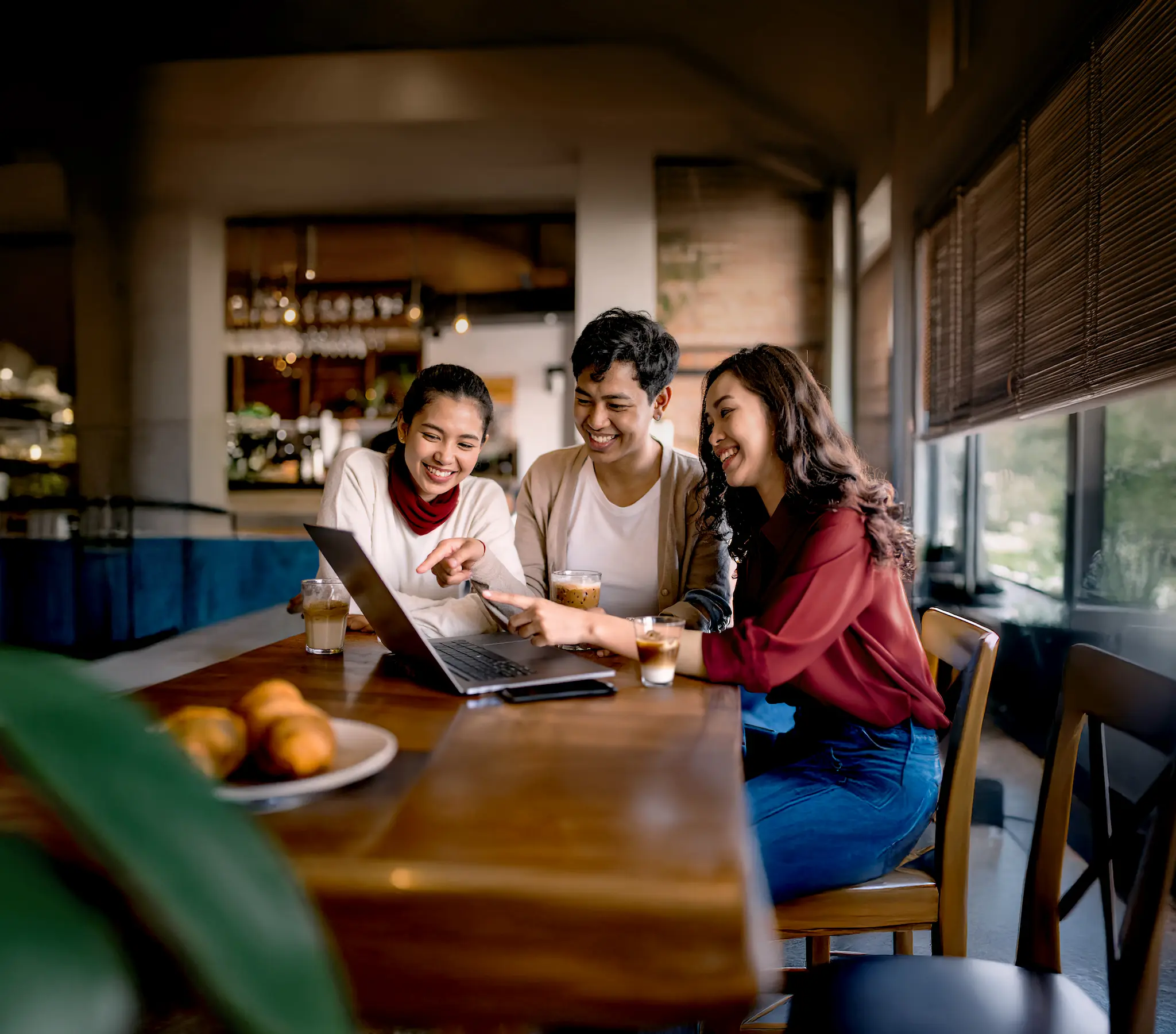 Two women smiling in a modern office